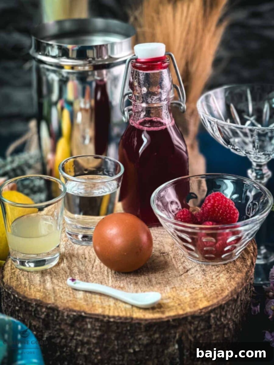 Clover club cocktail ingredients - gin, lemon juice, raspberry syrup, raspberries, egg white.