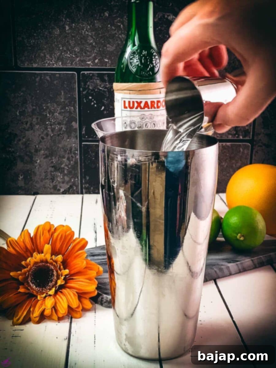 Add the white rum to the cocktail shaker.
