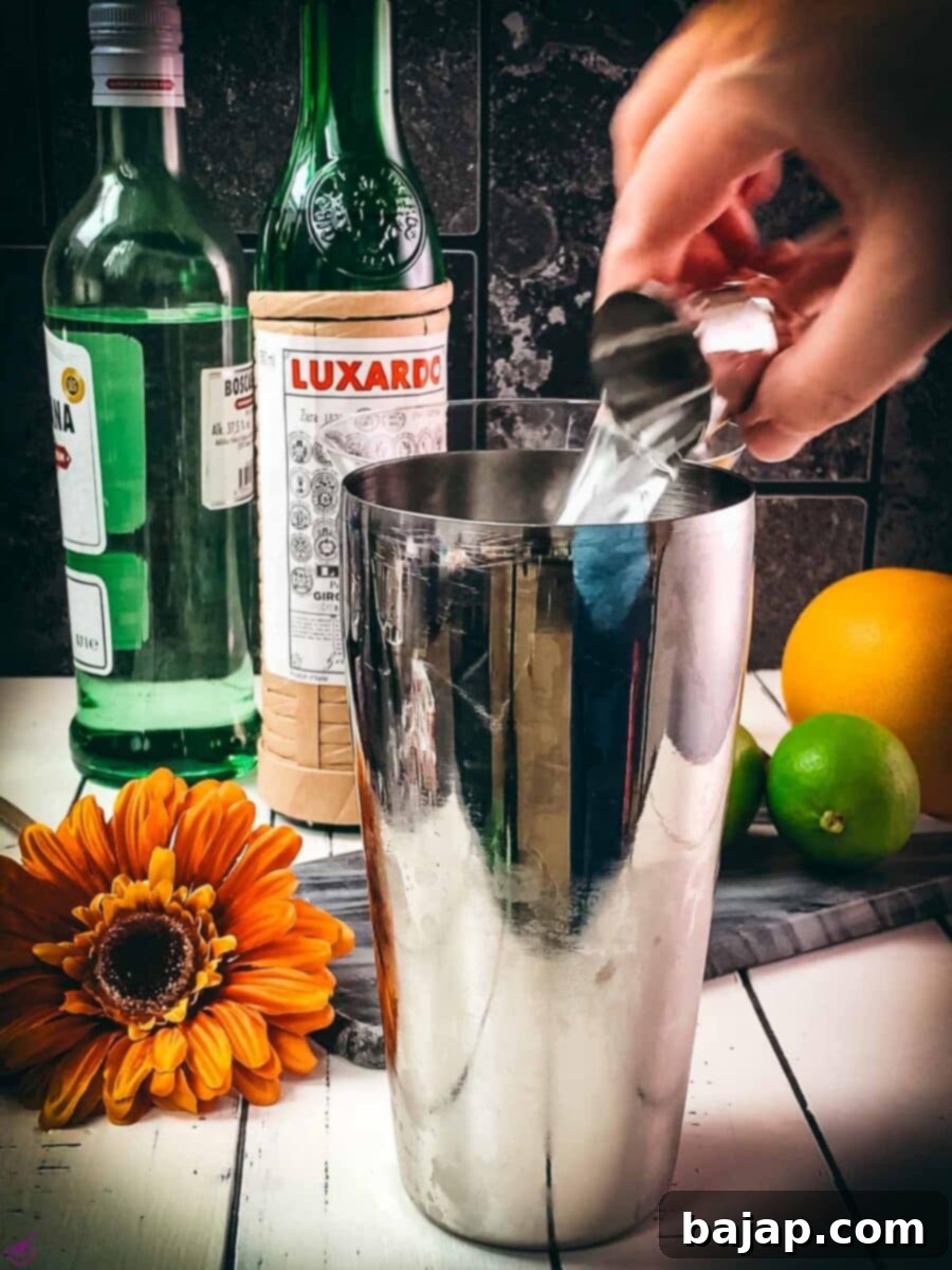 Add the maraschino liqueur to the cocktail shaker.