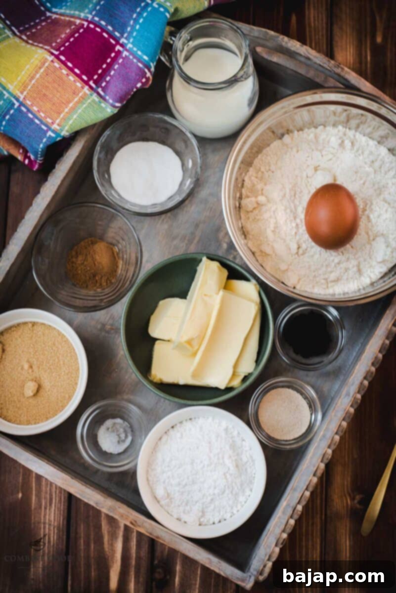 Ingredients for mini cinnamon rolls - egg, dry yeast, butter, flour, vanilla. milk, cinnamon, sugar, brown sugar, salt, powdered sugar.