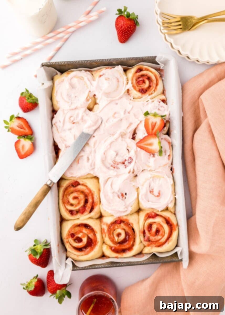 Soft and gooey strawberry cinnamon rolls, featuring fresh strawberry swirls and a sweet glaze.