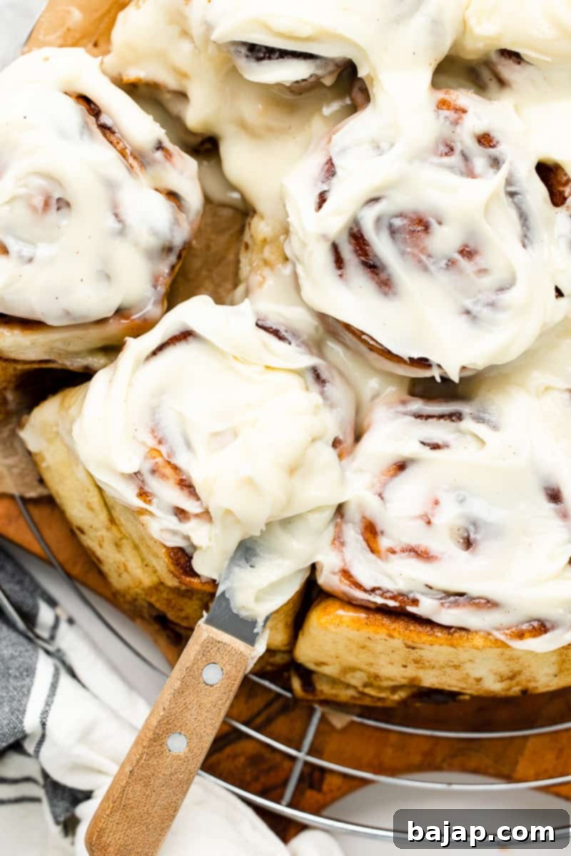 Golden-brown, frosted cinnamon rolls, perfectly cooked in an air fryer for a quick and easy treat.