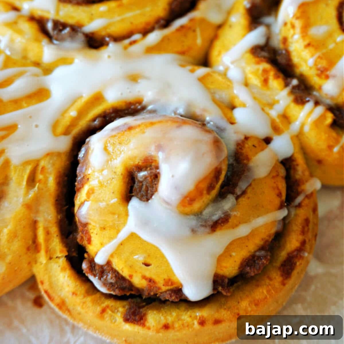 Fluffy Pumpkin Cinnamon Rolls topped with icing