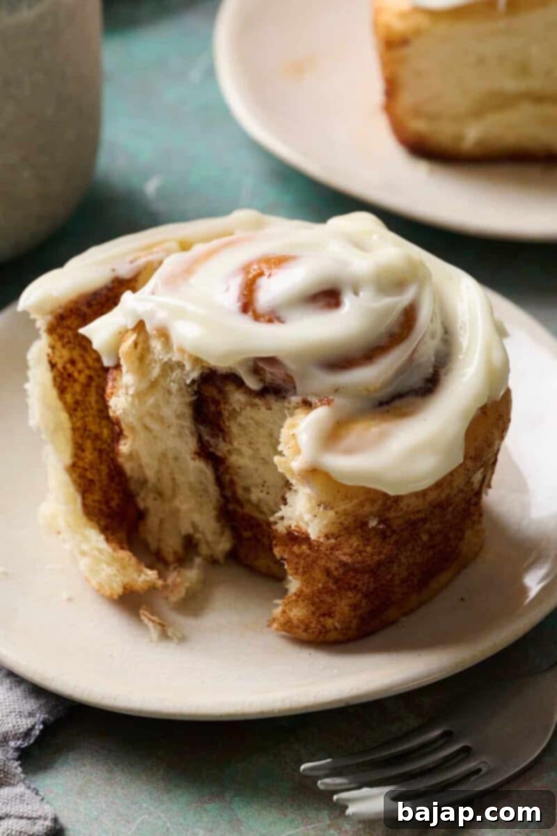Perfectly baked sourdough discard cinnamon rolls, generously topped with a creamy white frosting.