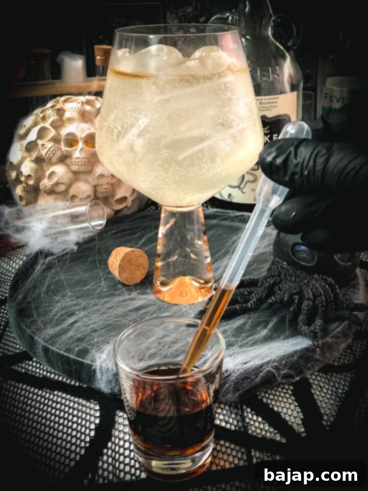 Retrieving the rum with a pipette for precise layering.