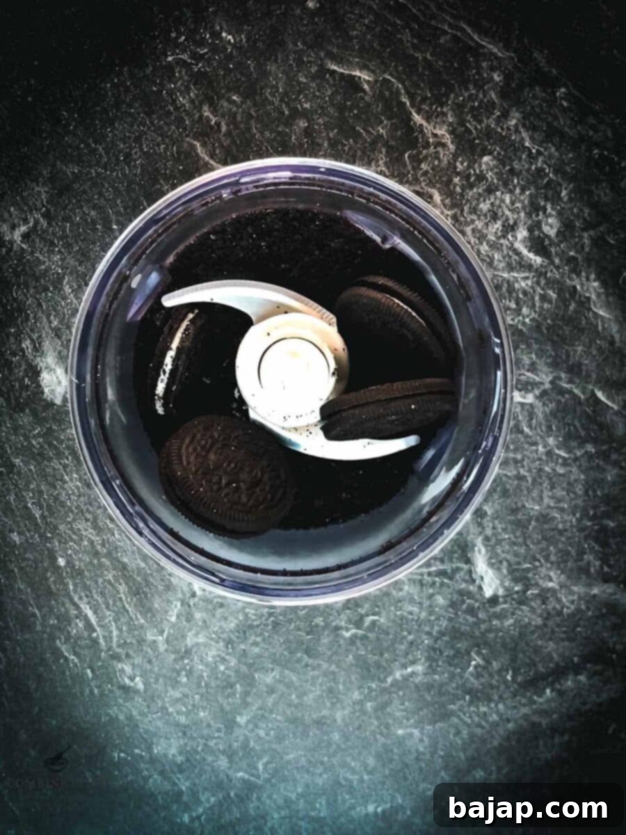 Crush the Oreo cookies using an electric chopper.