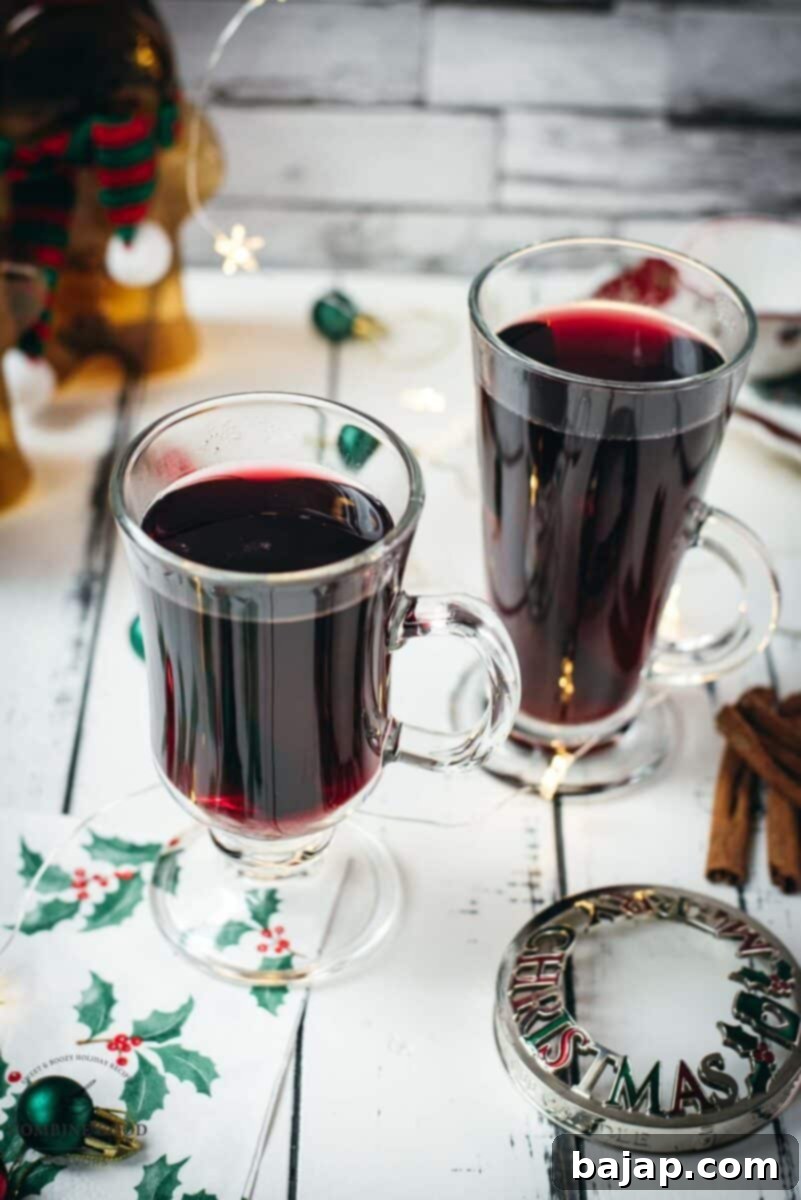 Warming Mulled Wine 2 Gorgeous glasses filled with mulled placed next to Christmas decor.