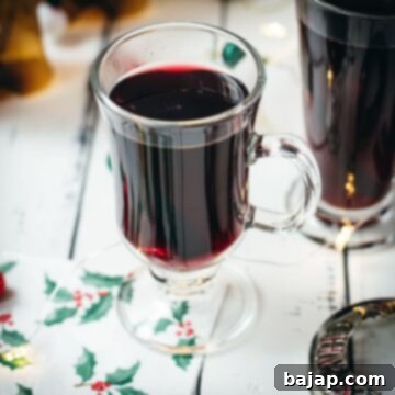Warming Mulled Wine 9 Gorgeous glasses filled with mulled placed next to Christmas decor.