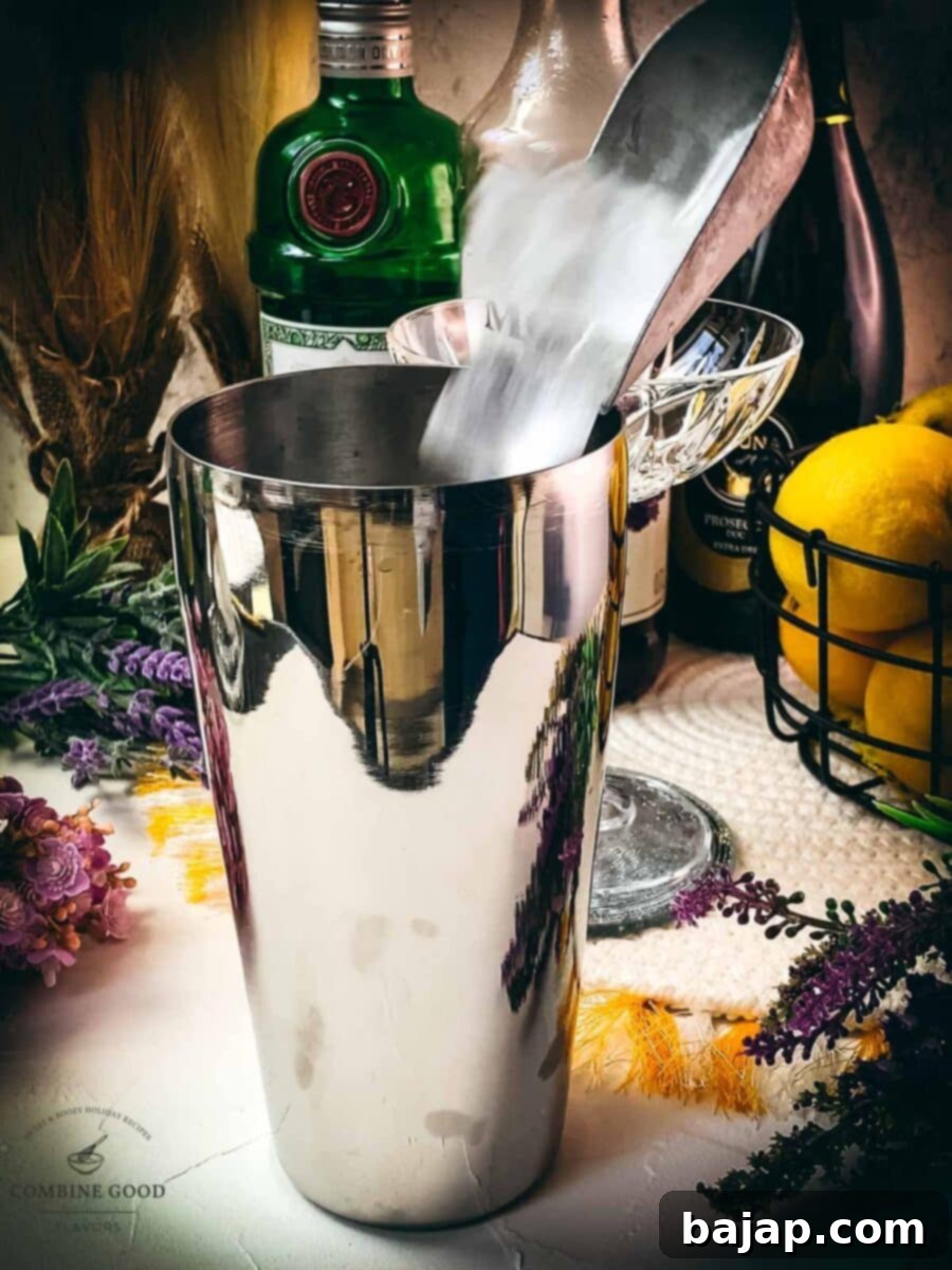 Fill your cocktail shaker with cubed ice, preparing for mixing.