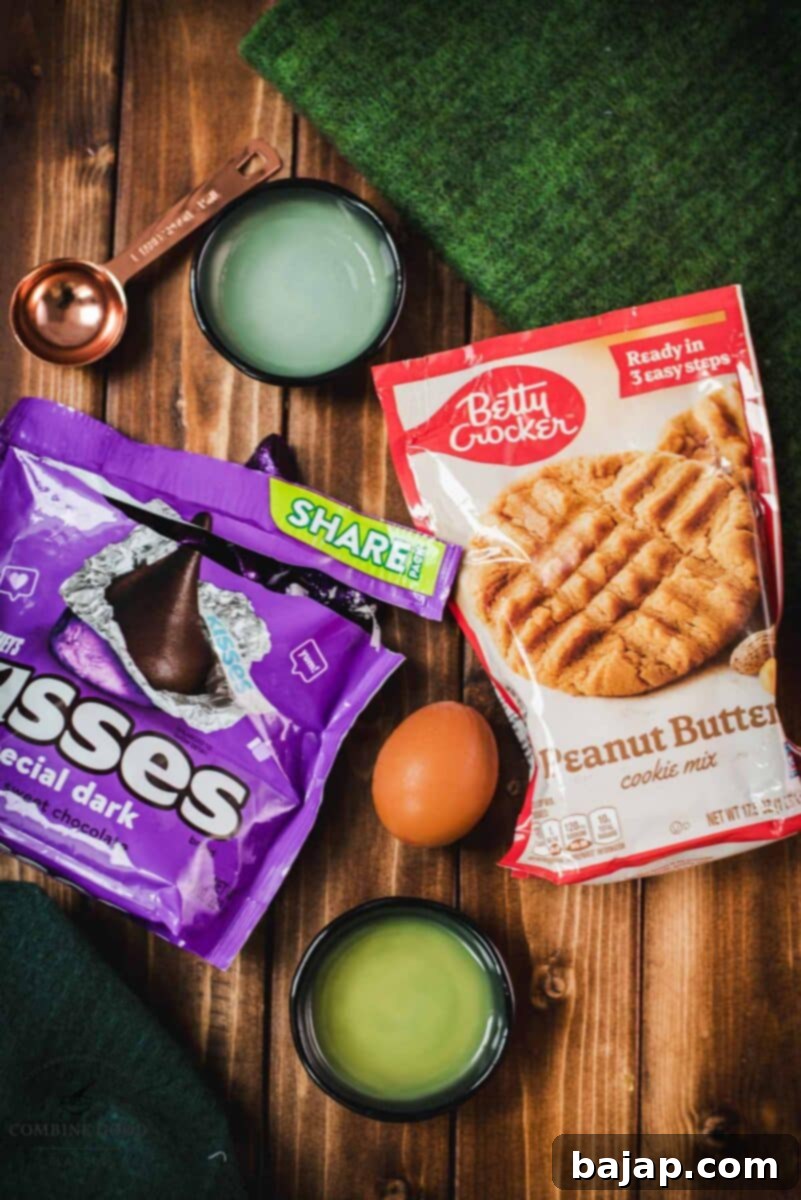 Essential ingredients for peanut butter blossoms: Betty Crocker peanut butter cookie mix, water, vegetable oil, egg, and Hershey's dark chocolate kisses.