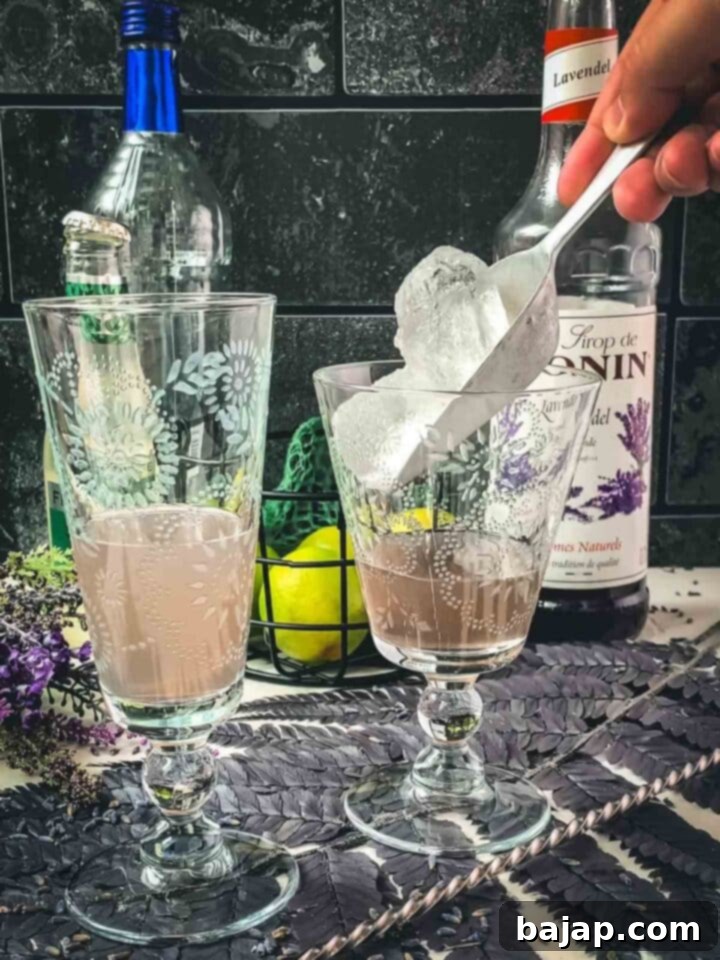 Add cubed ice to the serving glasses.
