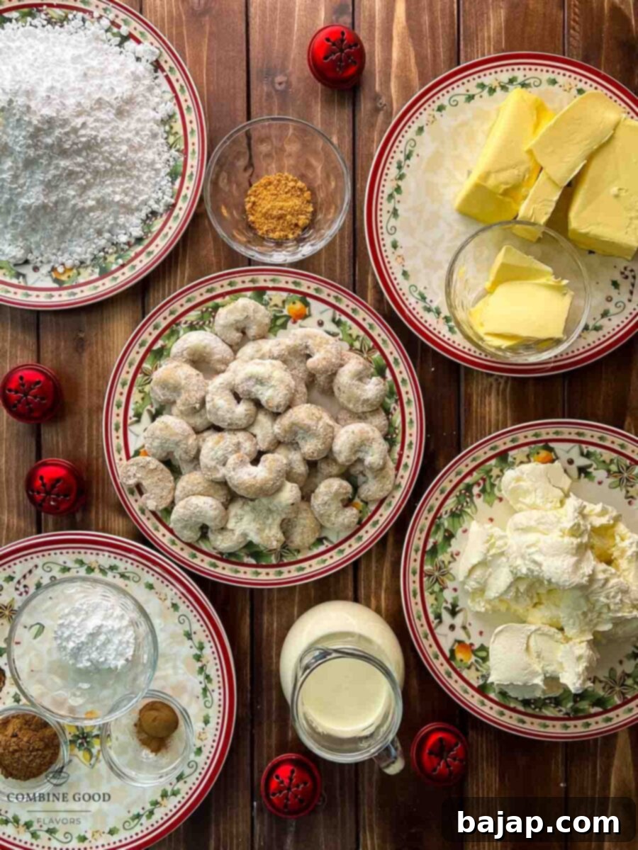 Collection of fresh ingredients for a no-bake vanilla crescents cheesecake, including butter, powdered sugar, cream cheese, vanilla crescents, orange zest, cinnamon, heavy cream, and white chocolate snowflakes.