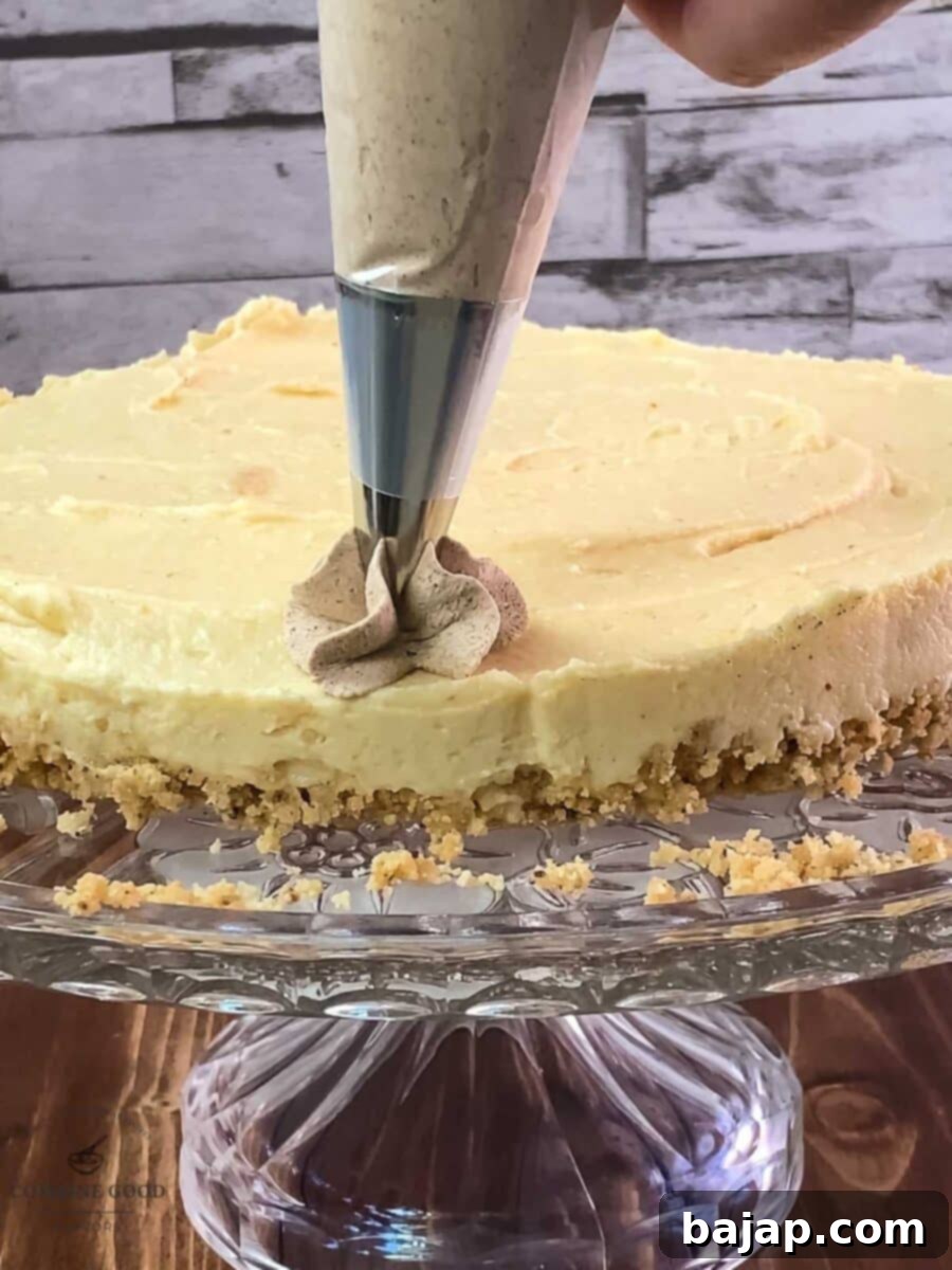 Pipe delightful cinnamon-flavored whipped cream in decorative dots on top of the cheesecake, showcasing the festive garnish.