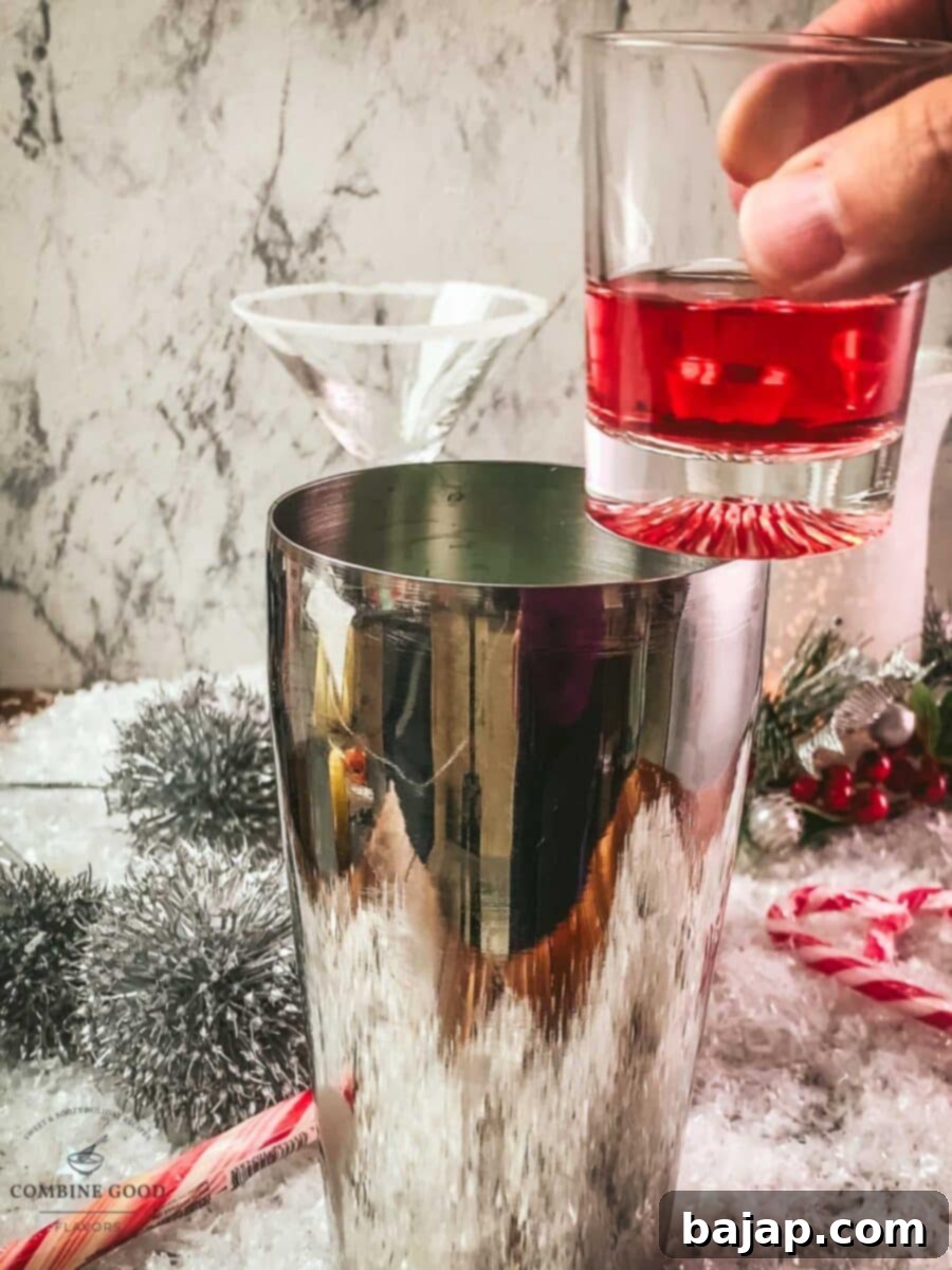 Add cranberry juice to the cocktail shaker.