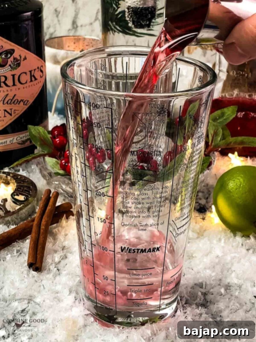 Add cranberry juice to the cocktail shaker.