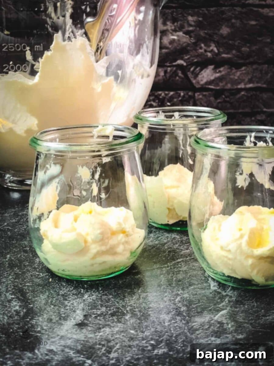 Holiday Trifle Shots 6 The first layer of creamy mascarpone mix in mini Christmas trifles.
