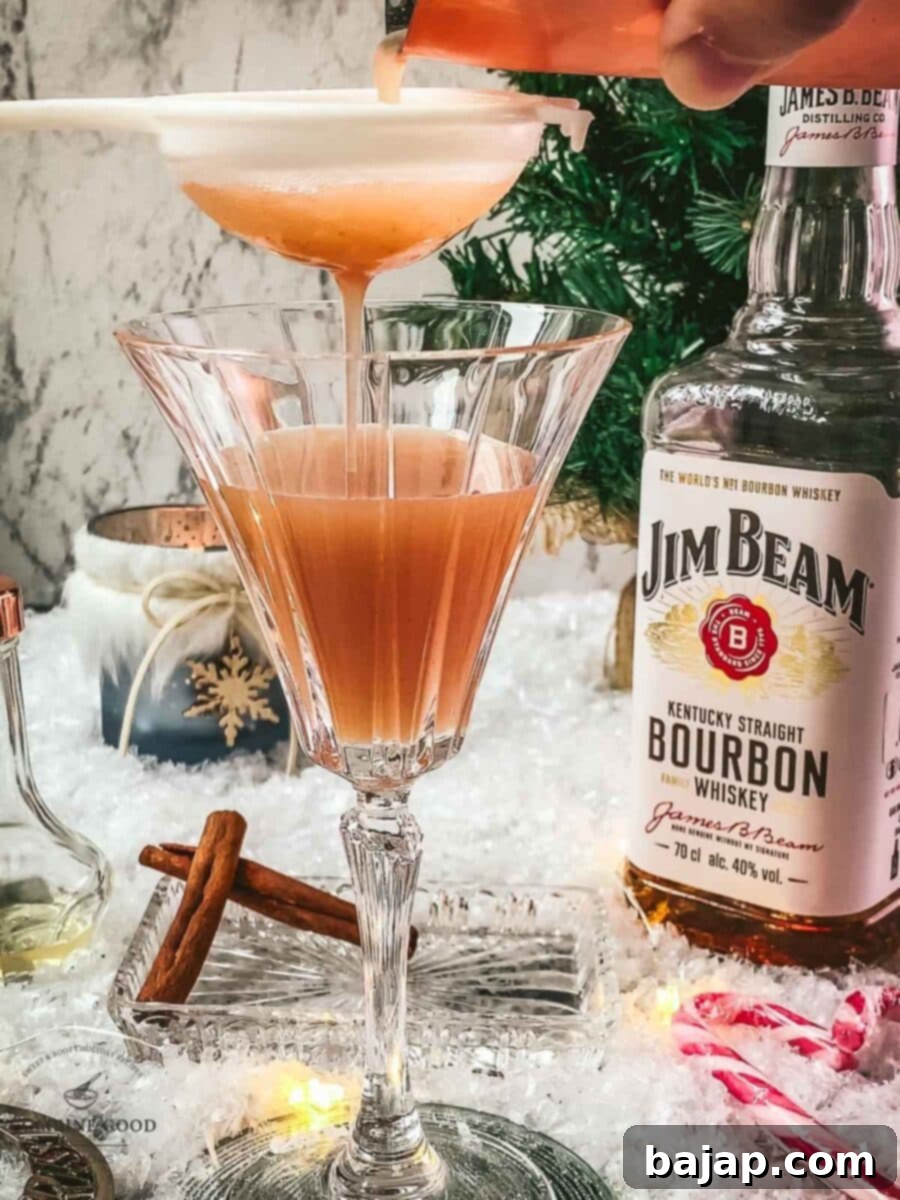 Fine strain your Cranberry Cinnamon Whiskey Sour into the serving glass.