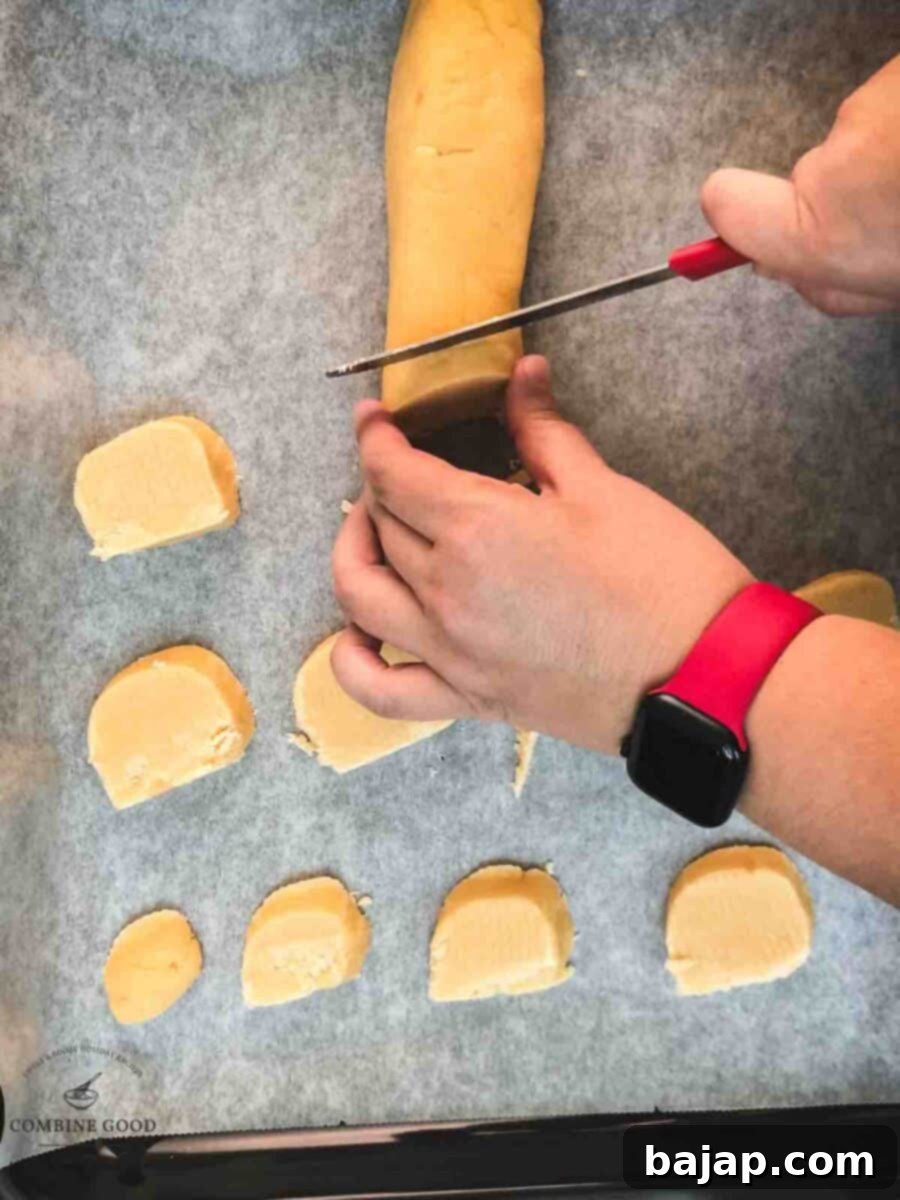 Cut the cold dough roll into finger thick slices.