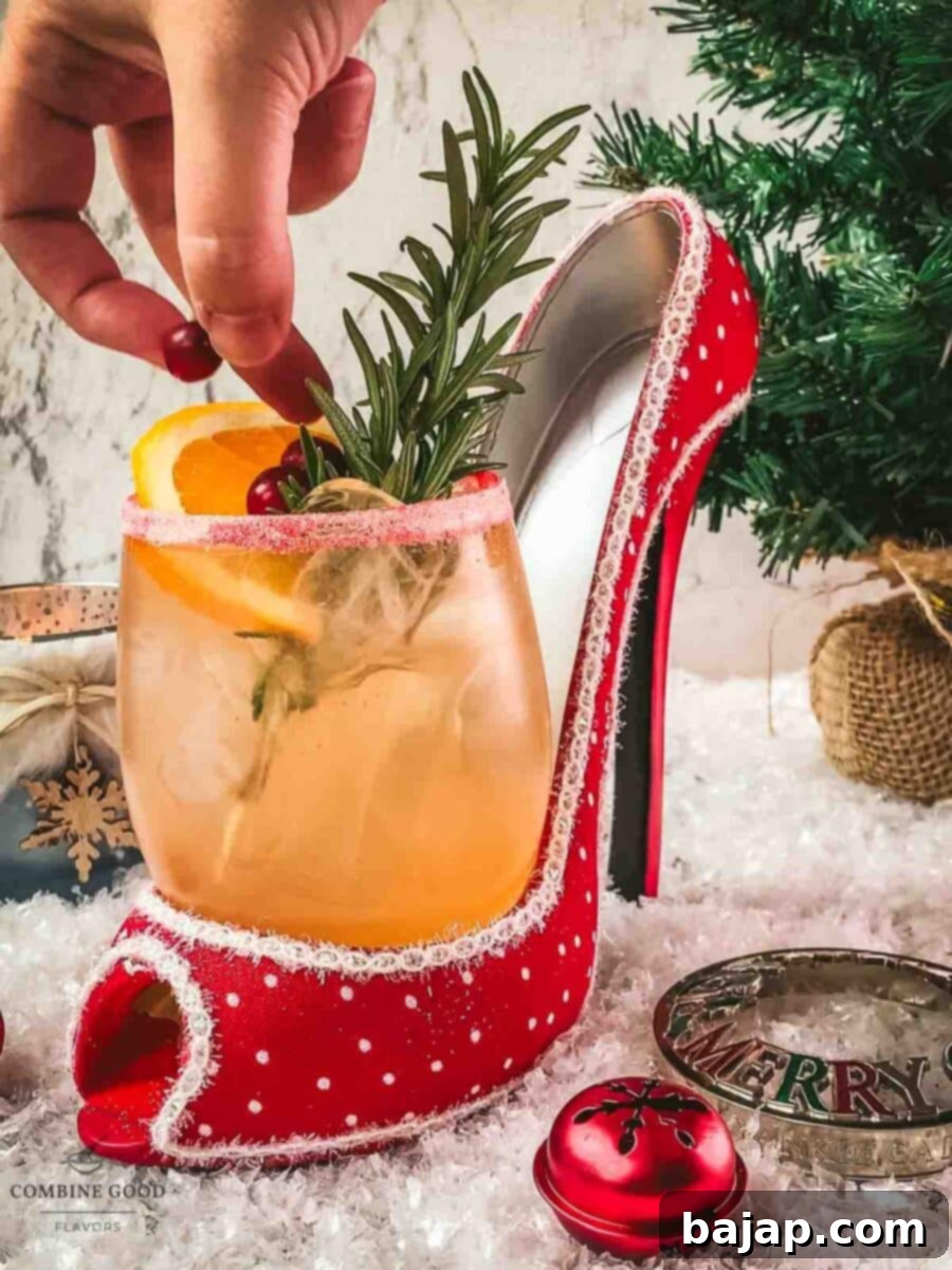 Adding fresh cranberries as a garnish to the festive Cranberry Vodka Spritzer.