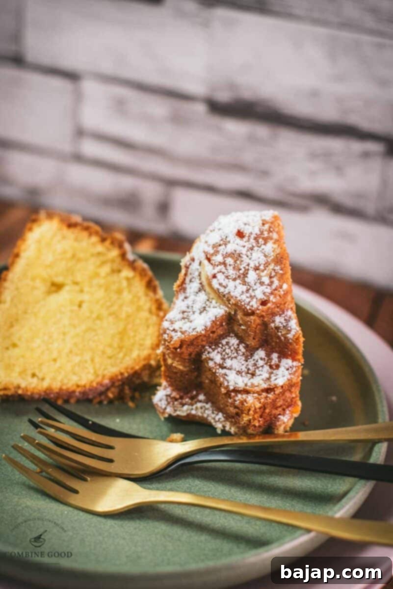 Gorgeous six egg yolk bundt cake slice, dusted with powdered sugar, and placed on green plate.