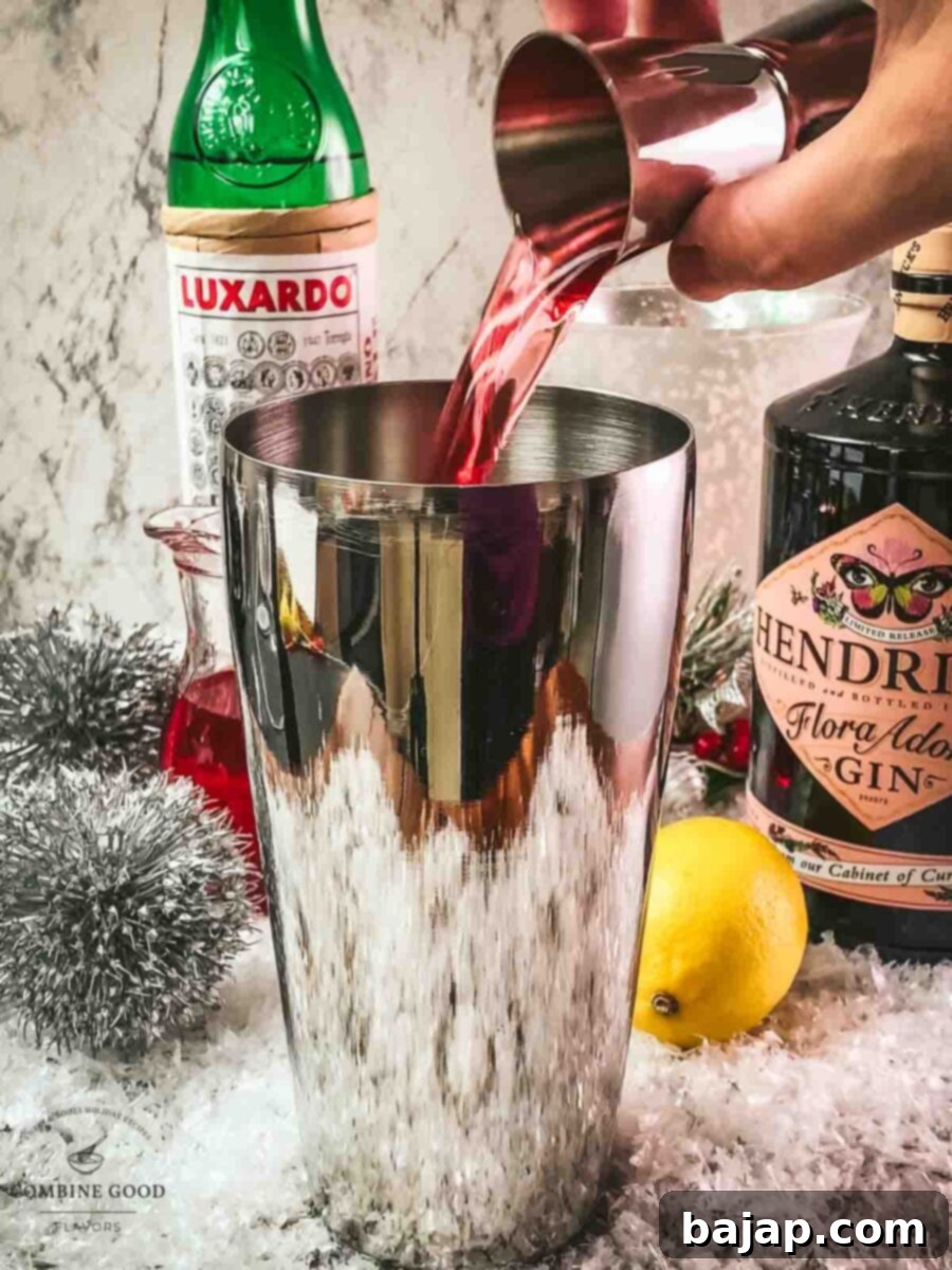 Add cranberry juice to the shaker tin.