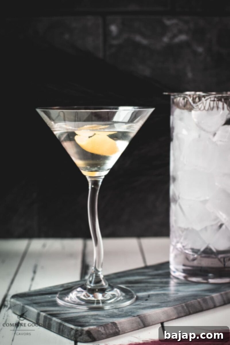 A perfectly crafted classic martini, elegantly garnished with a lemon twist, demonstrating the simple beauty of this iconic cocktail.