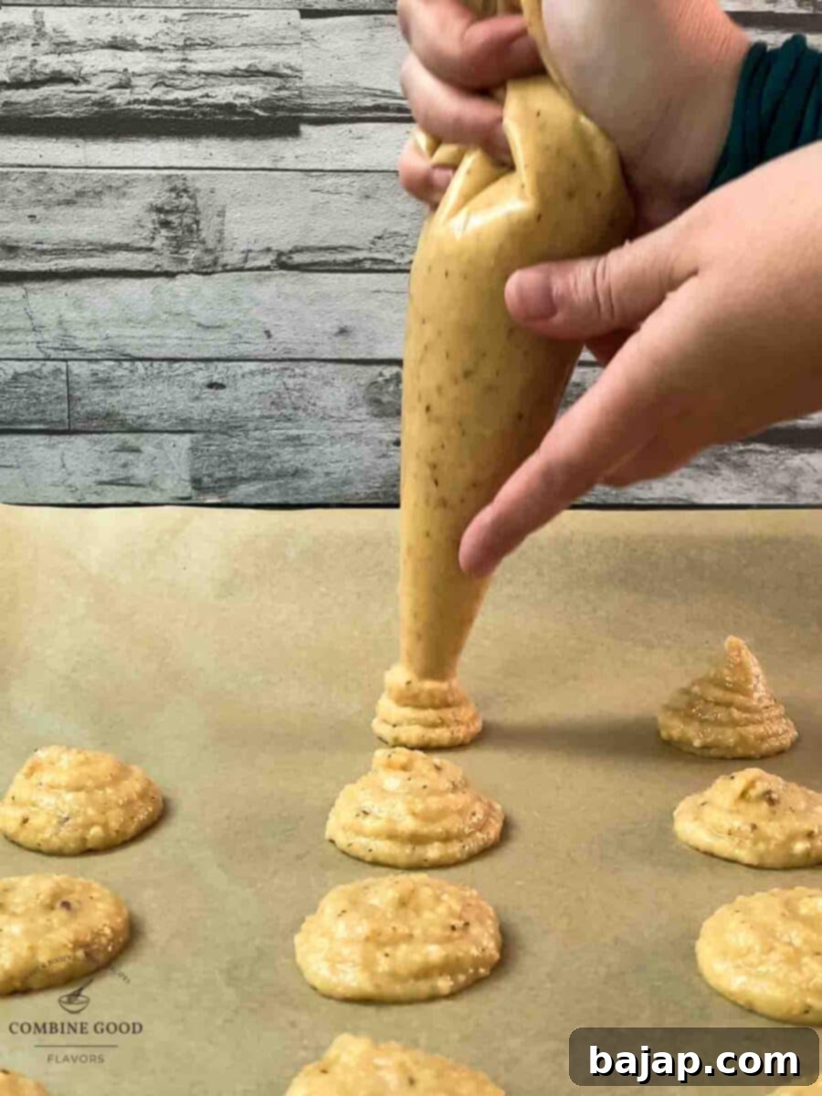 Pipe small heaps of hazelnut batter on a baking sheet lined with parchment paper.