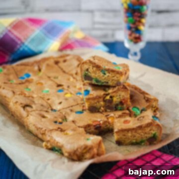 Colorful M and M Cookie Bars 10 Delicious M&M cookie bars on parchment paper.