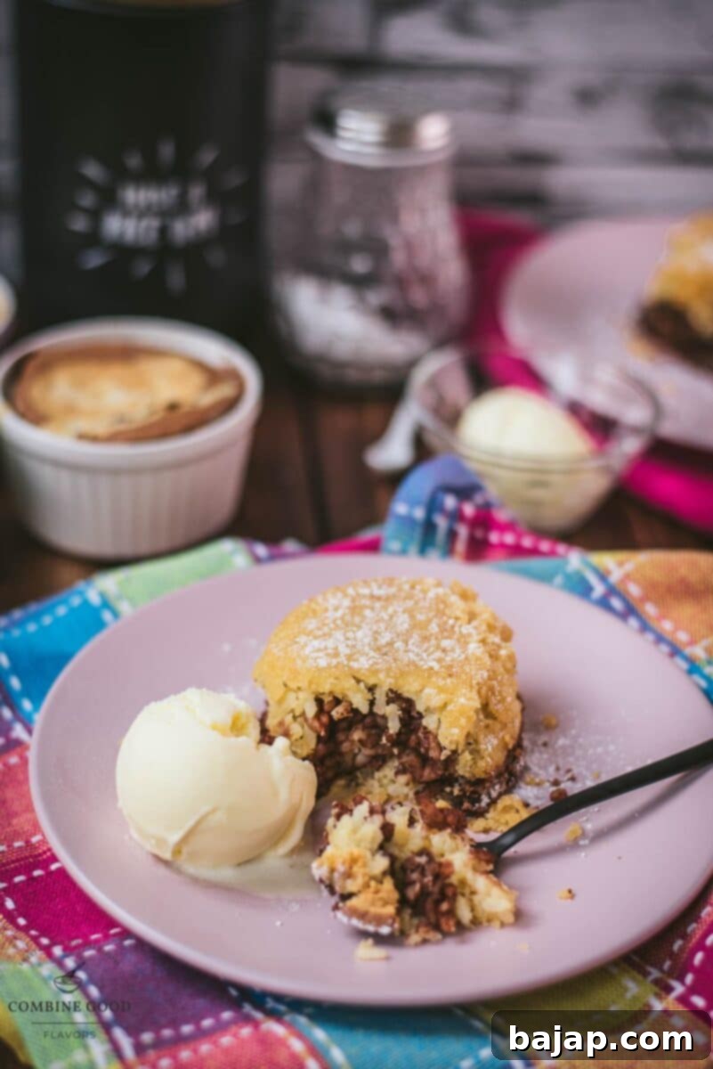 Delicious marbled rice pudding mini casserole on pink plate, served with a scoop of vanilla ice cream.