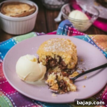 Creamy Baked Rice Pudding 19 Delicious marbled rice pudding mini casserole on pink plate. Served with a scoop of vanilla ice cream.