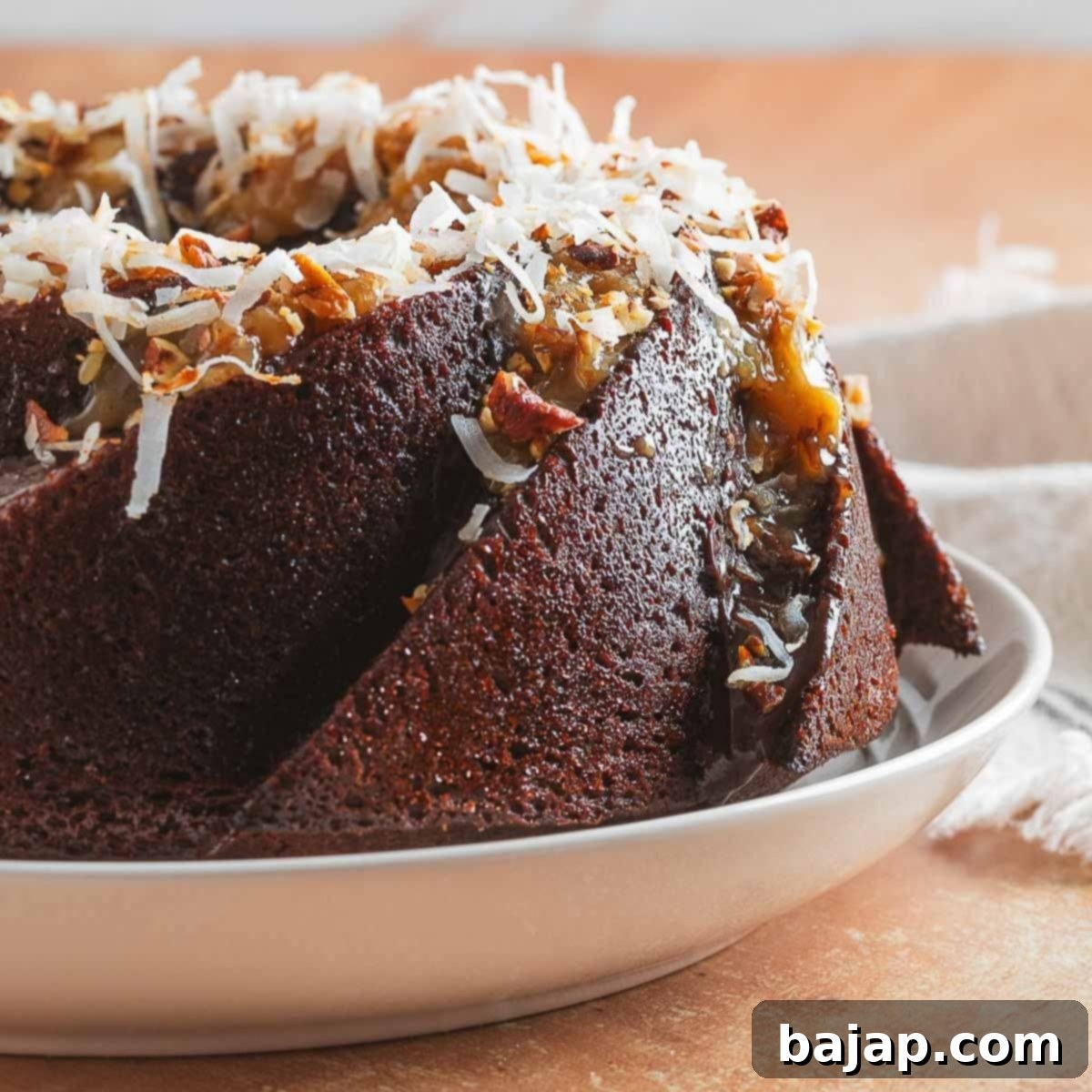 A classic German Chocolate Bundt Cake, topped with coconut-pecan frosting and chocolate ganache.