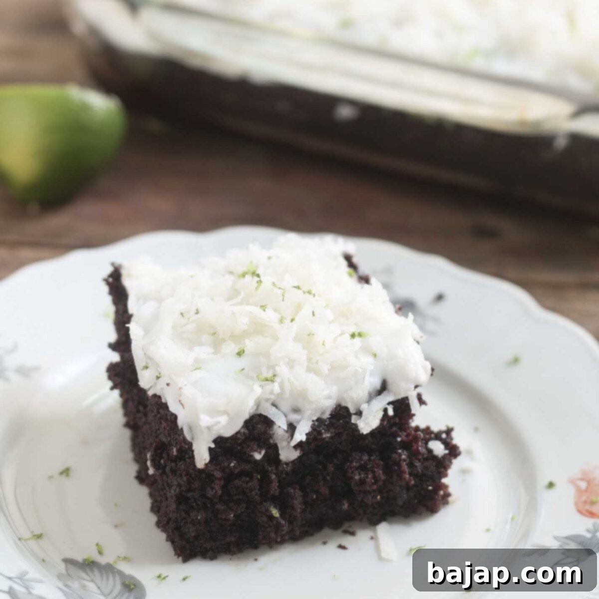 A slice of Hershey's Chocolate Cake with coconut lime frosting.