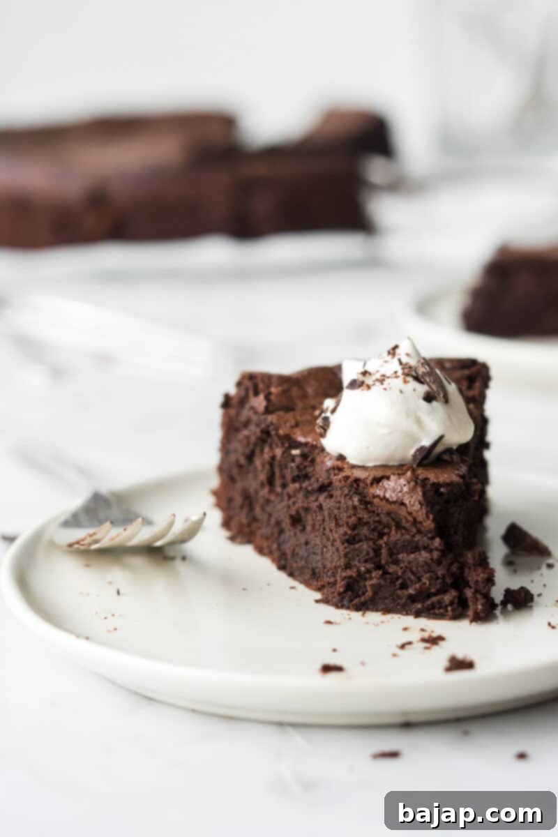 A fallen Chocolate Espresso Souffle Cake with a crackly top and boozy cream.