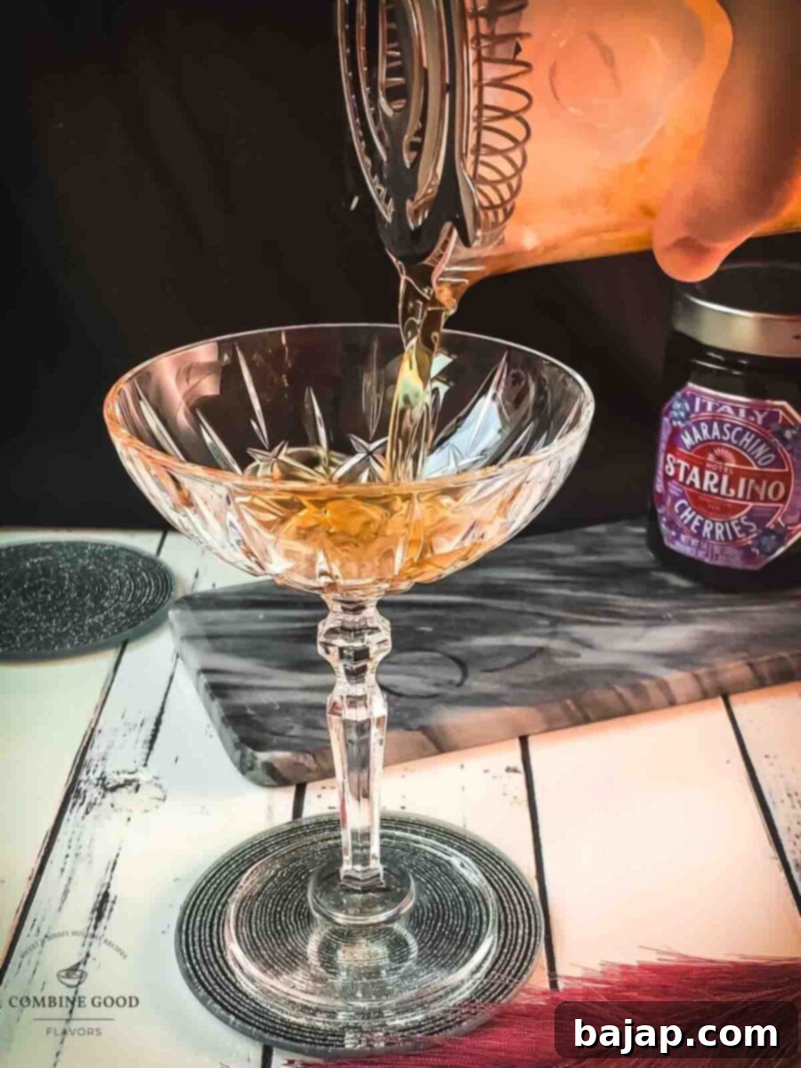 Strain the Manhattan into a chilled cocktail glass.
