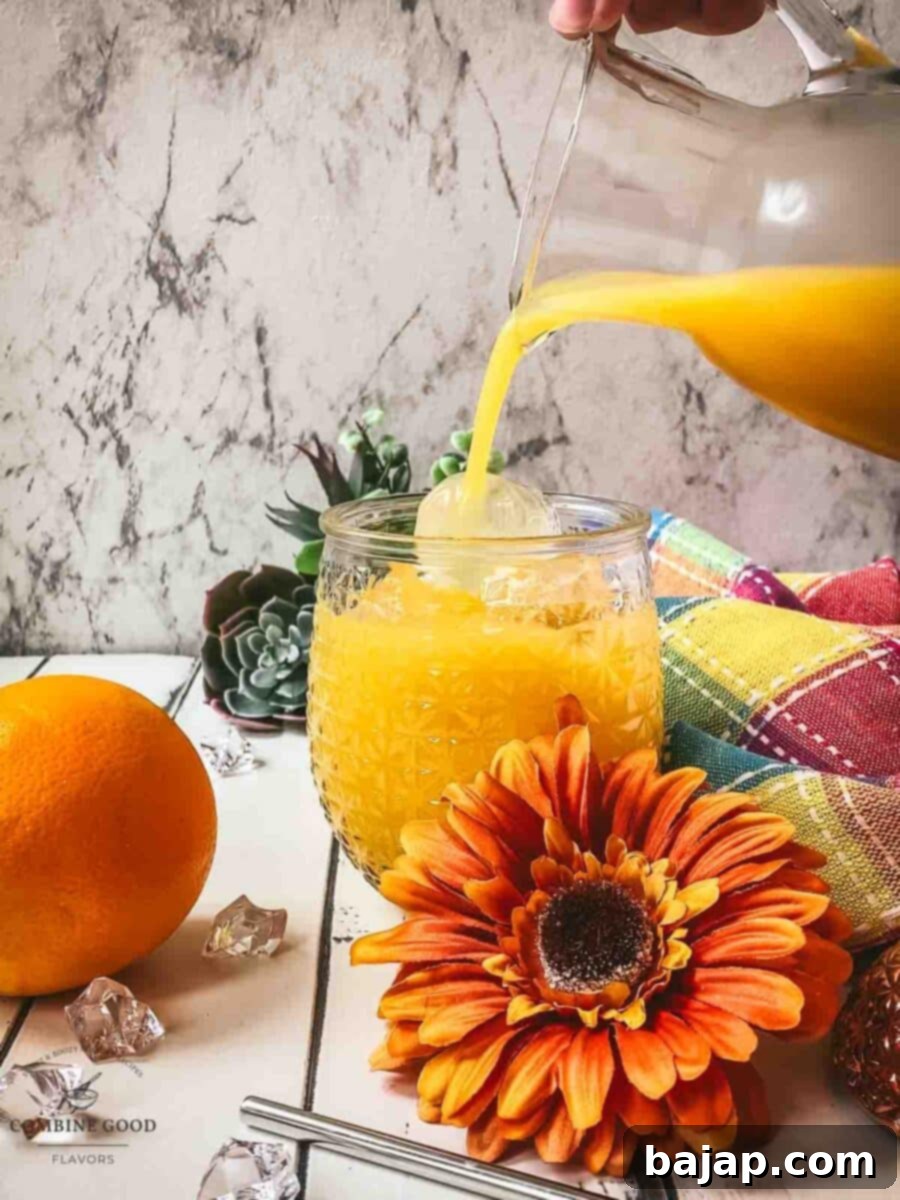 Top the vodka filled serving glass with orange juice.