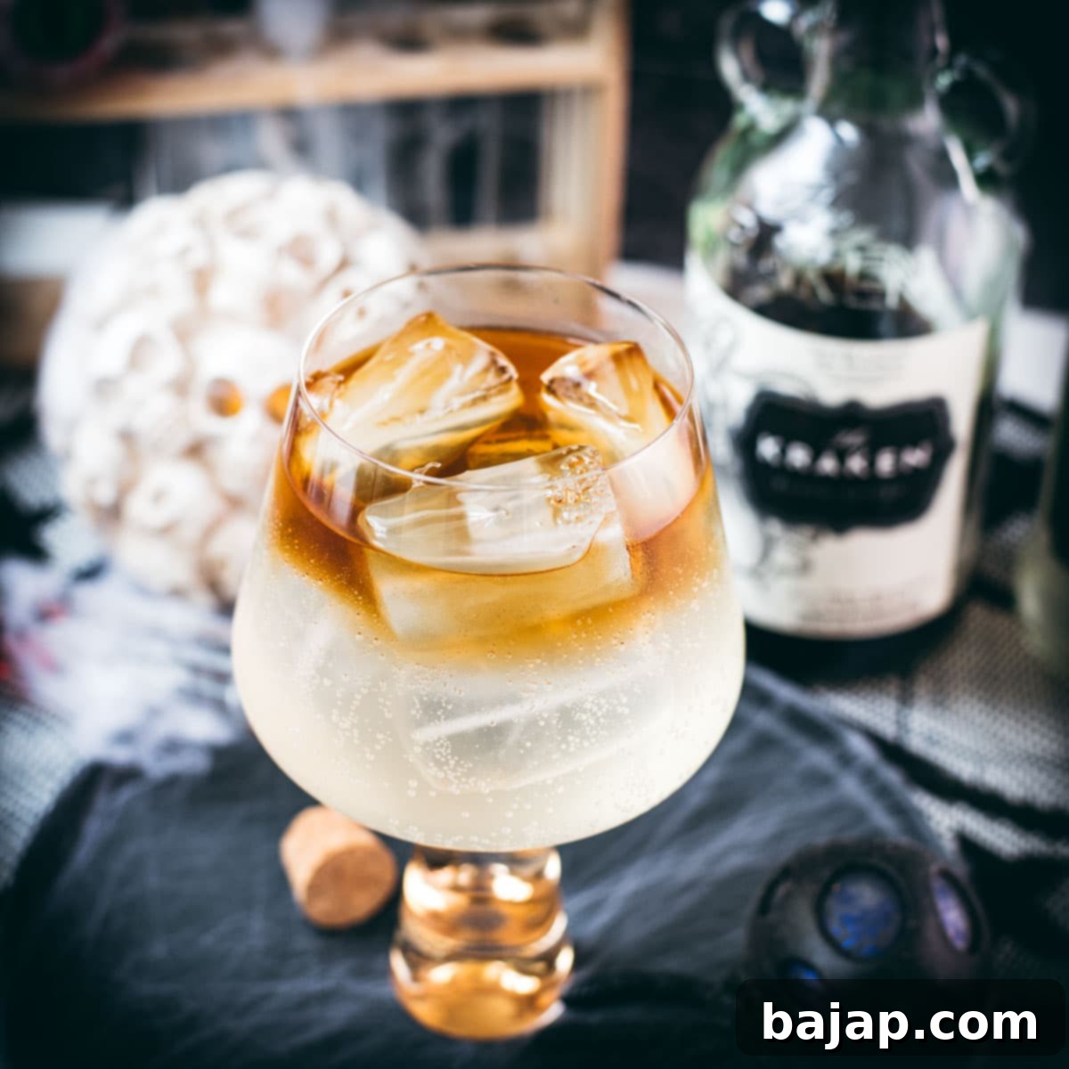 Gorgeous layered kraken ginger beer cocktail with spooky decoration.