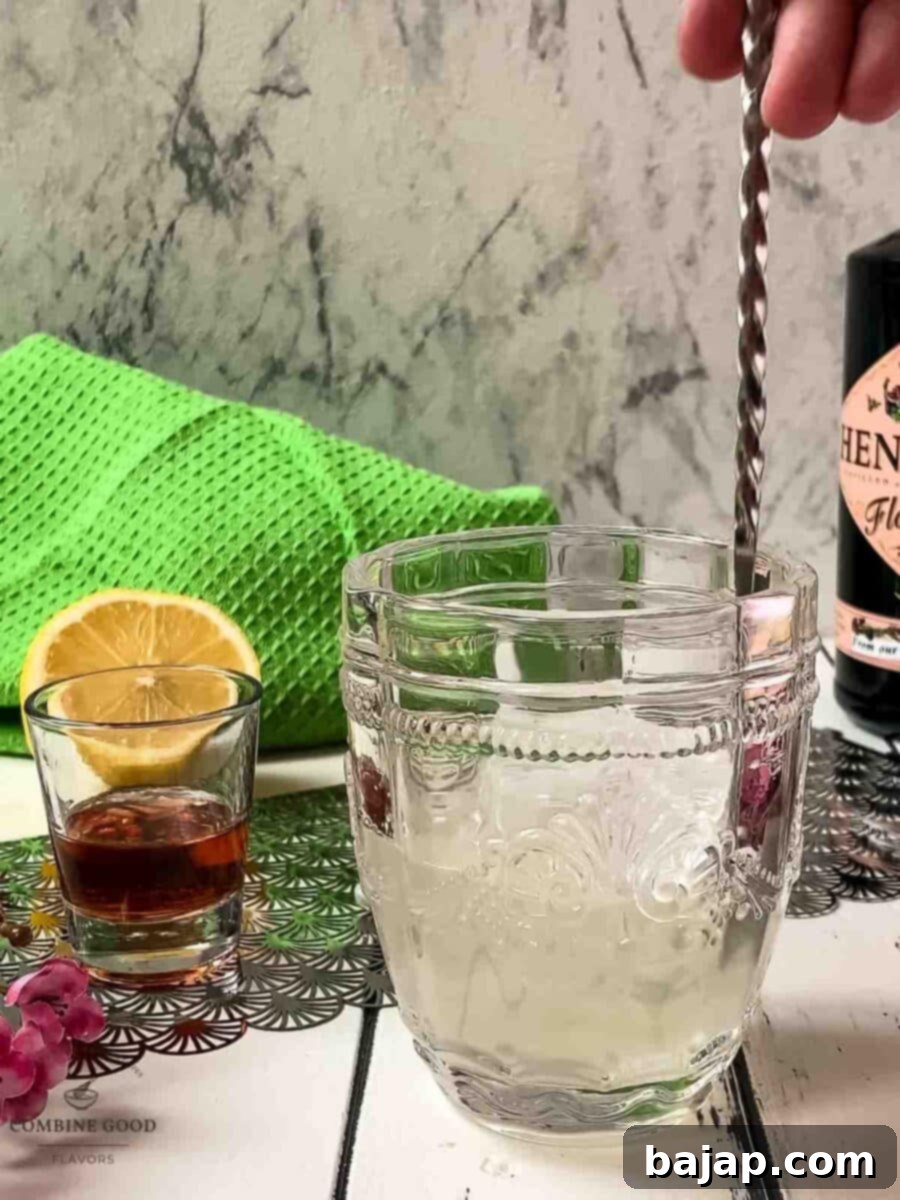 Stir the liquids with a bar spoon.