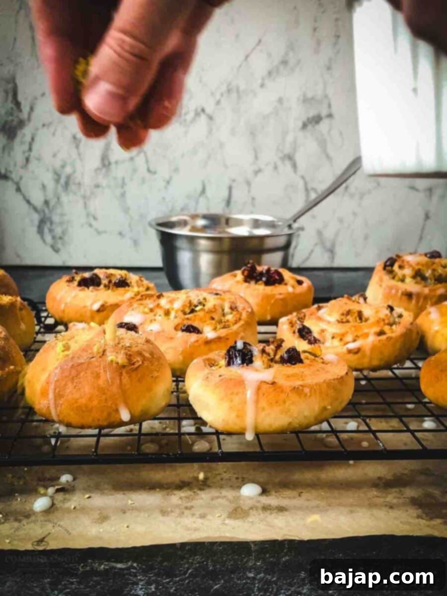 Sprinkle the glazed pistachio sweet rolls with ground pistachios.
