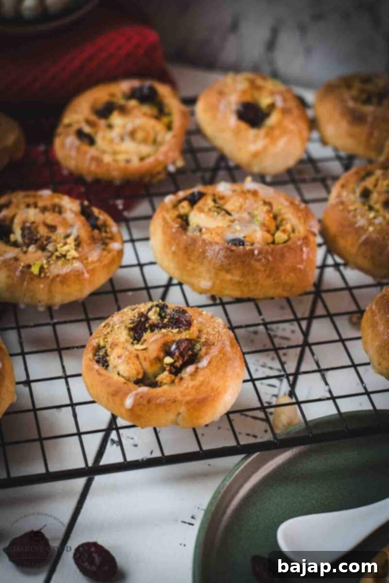 Delicious, mini pistachio sweet rolls on cooling rack.