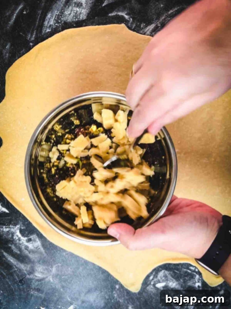 Combine the egg white, chopped pistachios, cranberries, and marzipan in a mixing bowl.