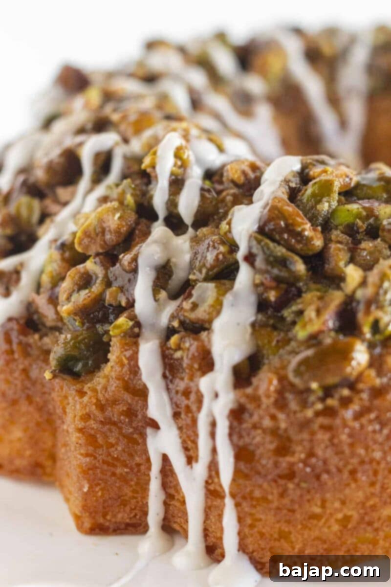 A beautifully inverted Pistachio Bundt Cake, revealing a rich pistachio topping.