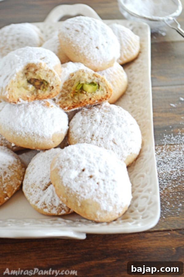 Traditional Kahk Eid cookies, super buttery, dusted with powdered sugar, and filled with pistachios and honey.