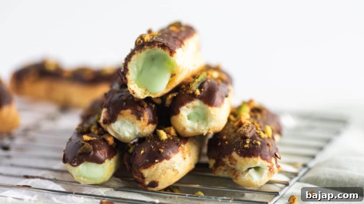 Homemade chocolate pistachio eclairs, filled with creamy pistachio pudding and drizzled with chocolate.