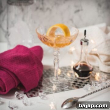 Cocktail glass filled with an elegant pink gin cocktail.