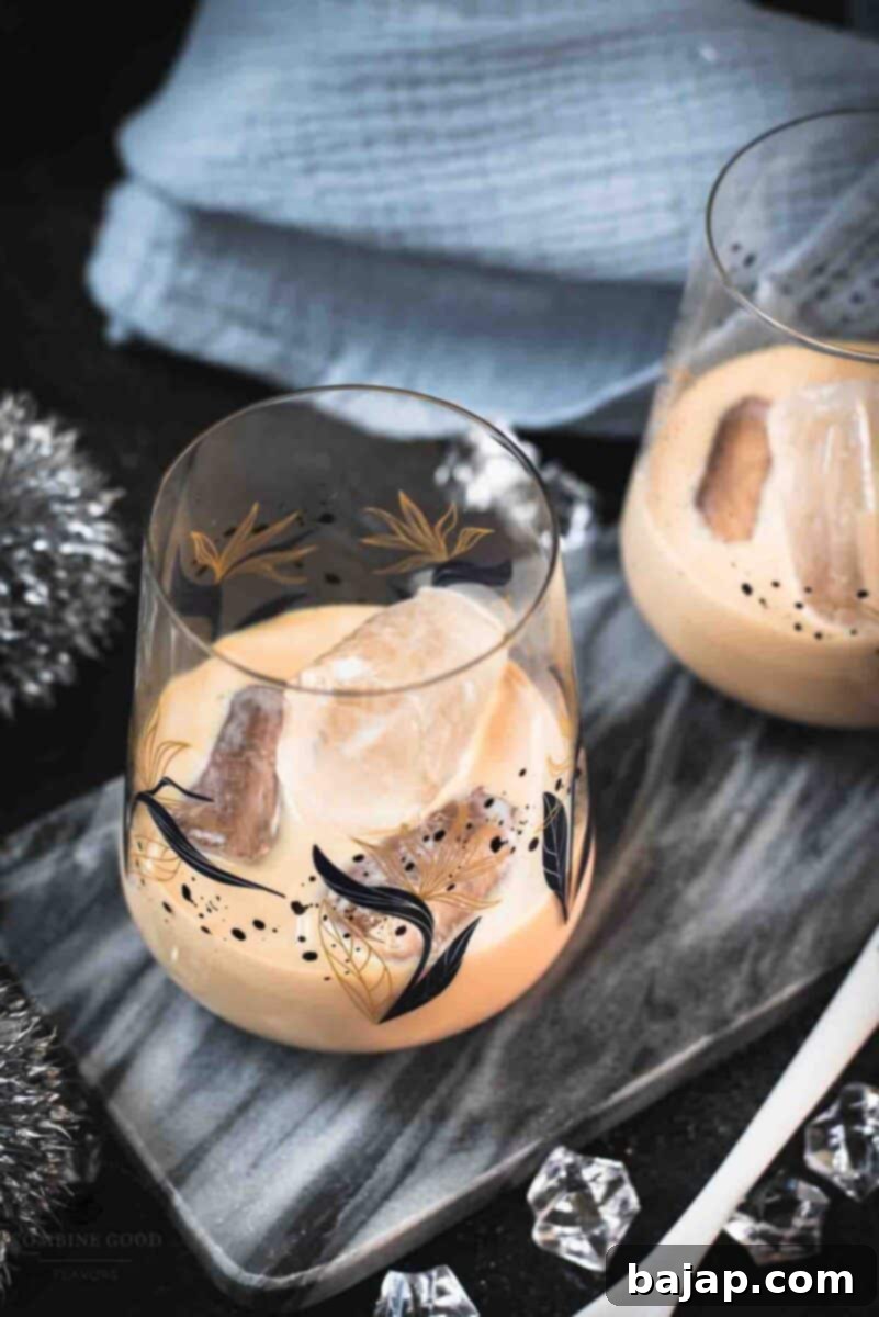 Velvet Frost 7 Two elegant tumbler glasses filled with delicious Baileys Irish Cream on the rocks, presented beautifully on a marbled plate.