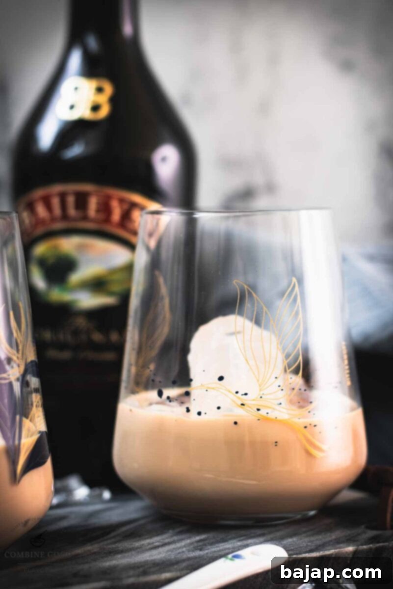 Velvet Frost 8 Cute tumbler glasses filled with delicious Baileys Irish Cream on the rocks. Placed on marbled plate.