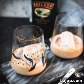 Velvet Frost 9 Two cute tumbler glasses filled with delicious Baileys Irish Cream on the rocks. Placed on marbled plate.