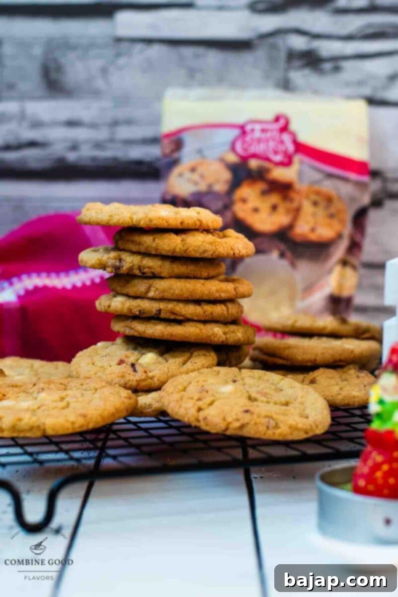 Soft, chewy, and sweet strawberry white chocolate chip cookies, stacked on a cooling rack.
