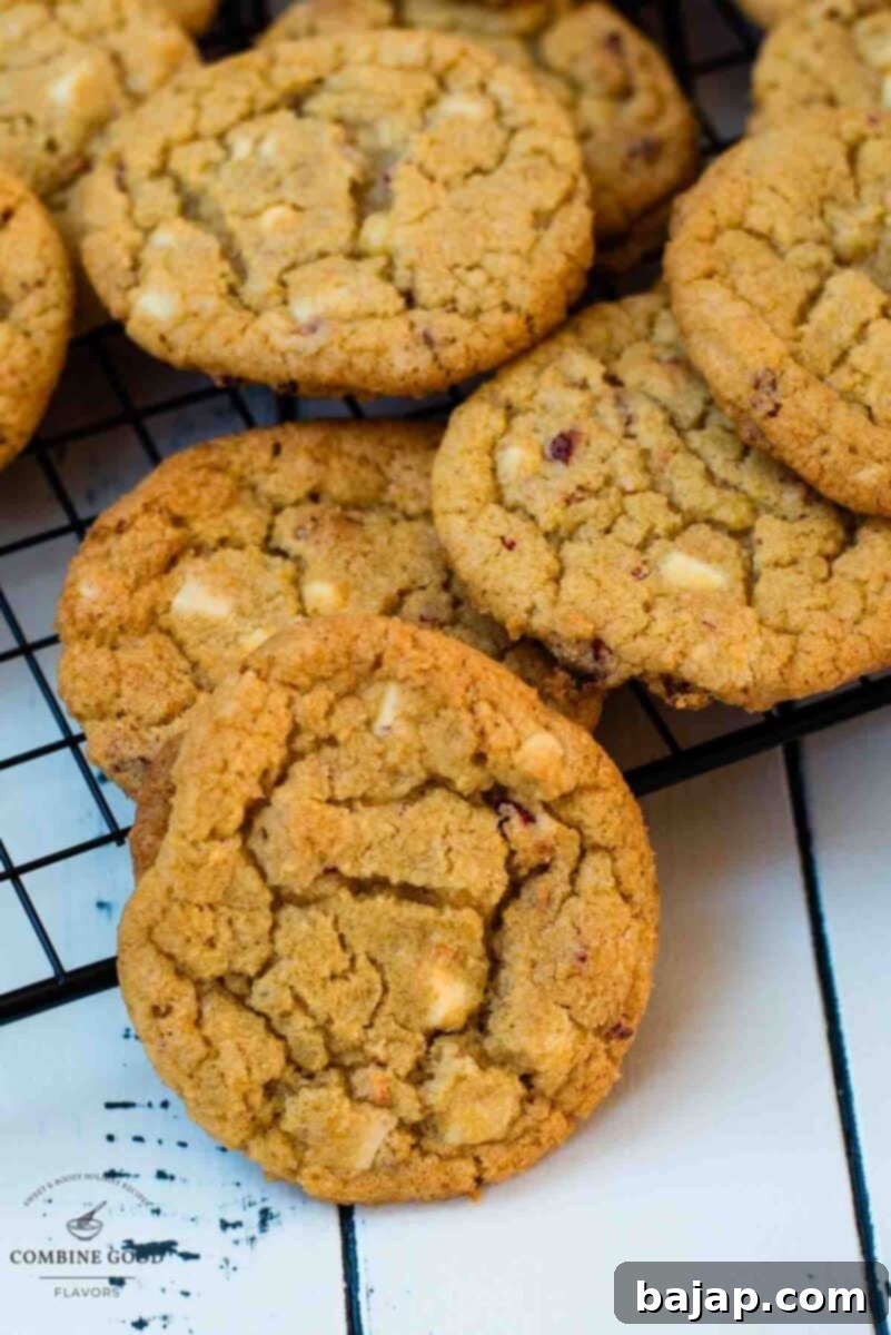 Soft, chewy and sweet strawberry cookies with white chocolate chips scattered on a cooling rack.