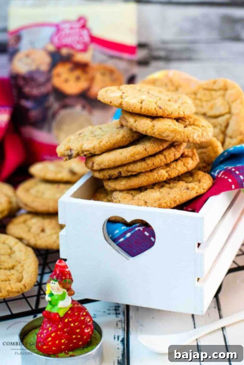 Soft, chewy and sweet strawberry cookies with white chocolate chips placed in a gorgeous white wooden crate.